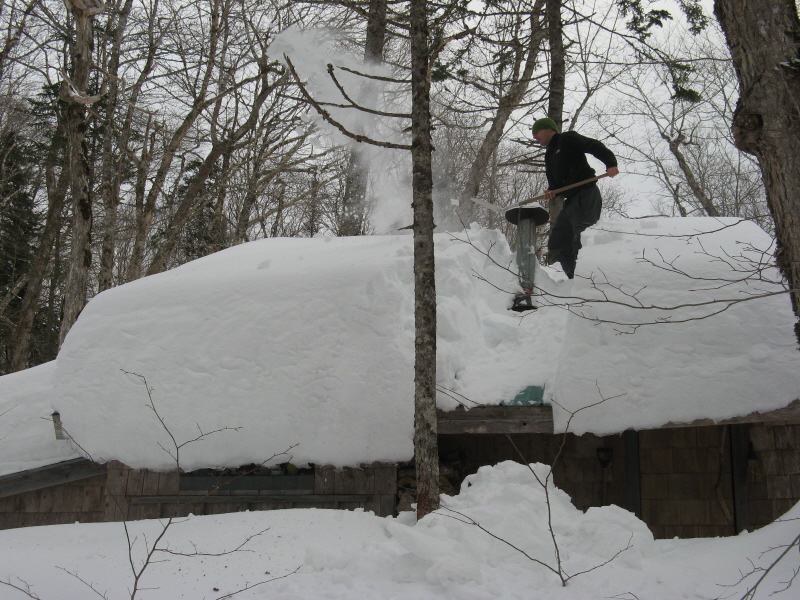 Angelo shovels off the Chalet Roof